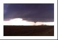 An obvious funnel has formed toward the southern edge of the mesocyclone.  At this time the storm is actually producing baseball-size hail a few miles straight ahead – west of the mesocyclone – as it transitions to a classical supercell.