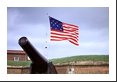 Canon pointed seaward protects the Fort McHenry battlesite while the flag forever waves.