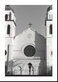 Large circular window flanked by two bell towers.