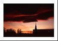 Wave clouds downwind of the Rockies are touched by scarlet red setting sun above a Longmont church (Latter-Day Saints).