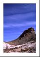 Billow clouds above a lunar-like landscape of rock in Big Bend Nat Park.