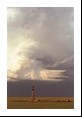 A wider view of the storm reveals a compact supercell with rotating updraft, sculpted cloud edges comprising the mesocyclone and a clear slot down the back due to the rear flank downdraft (plus the flowers and fence are nice too).