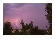 A single cloud-to-ground lightning bolt plus a faint rainbow - though quite common to see, not commonly photographed because of the difficulty photographing lightning in daytime.