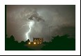 A wide bolt of lightning (cloud-to-ground) strikes behind this impressive house. This storm earlier produced a few tornadoes near St. Francis, KS on June 7, 1994 and later that night became a MCC (Mesoscale Convective Complex).