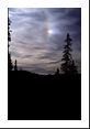 Perhelia (commonly called sun dog) occur to the left and right of the sun at 22 angular degrees as a result of thin cirrus clouds composed of ice crystals (hexagonal plates).