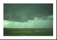 A small funnel forms at cloud base along with a very thin veil of dust column below but lasts under a minute. This represents the lowest end of the tornado spectrum.